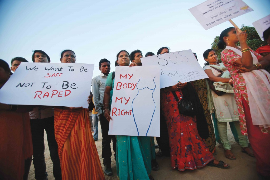 Demonstrators hold placards as they take part in a protest rally in solidarity with a rape victim from New Delhi in Mumbai