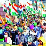 Farmers march holding the national flag during an ongoing protest against the three farm laws