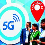 FILE PHOTO: People stand in front of a board depicting 5G network at the India Mobile Congress 2018 in New Delhi