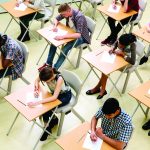Elevated view of students writing their GCSE exam